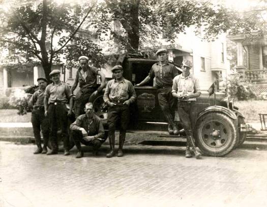 George, standing by spare tire.